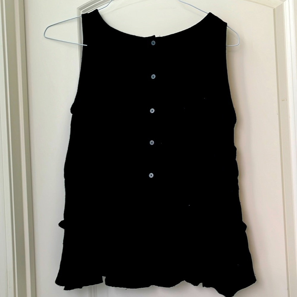 Medium LOFT sleeveless top with button up BACK and ruffles on the BACK hem.